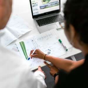 woman in white shirt writing on white paper